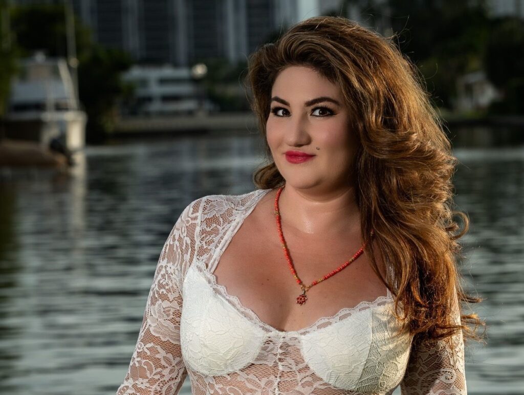 Karla Campos, mompreneur, showcasing flowing long hair and a feminine lace outfit in Miami.